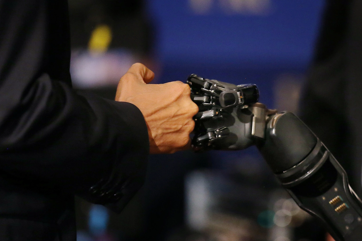 Obama and a Robotic Hand Controlled by Nathan Copeland fist bump